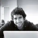 student smilin with computer